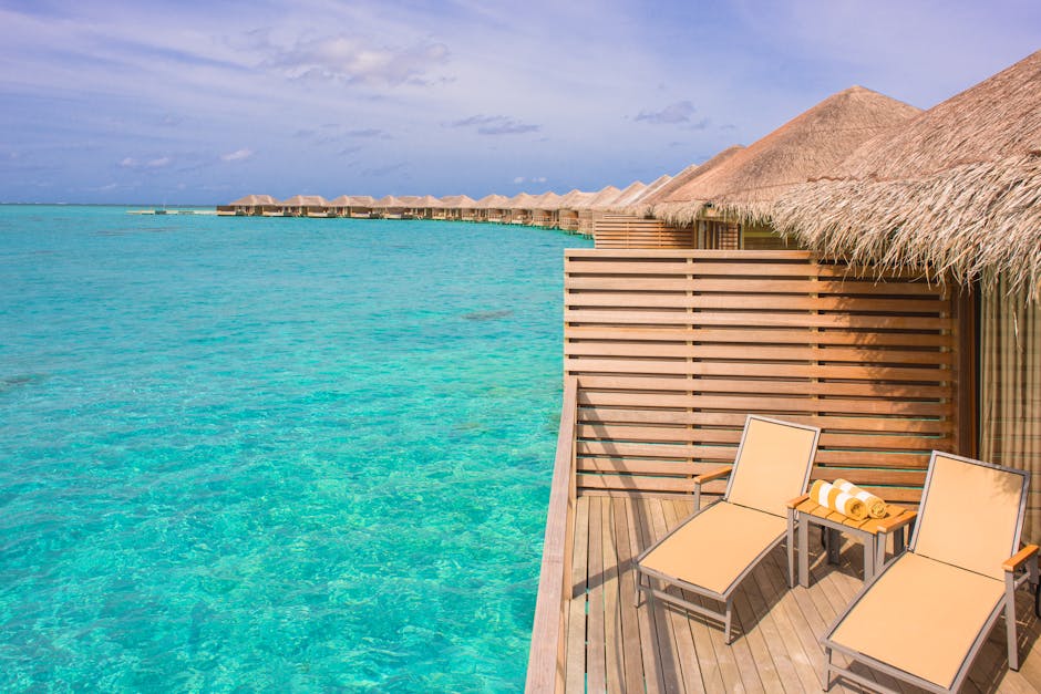 Scenic view of overwater bungalows in a tropical resort, with turquoise waters and clear skies.
