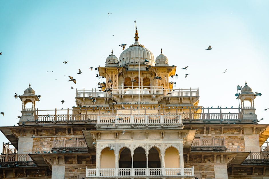 Stunning view of the Albert Hall Museum in Jaipur with birds in flight against a clear sky.