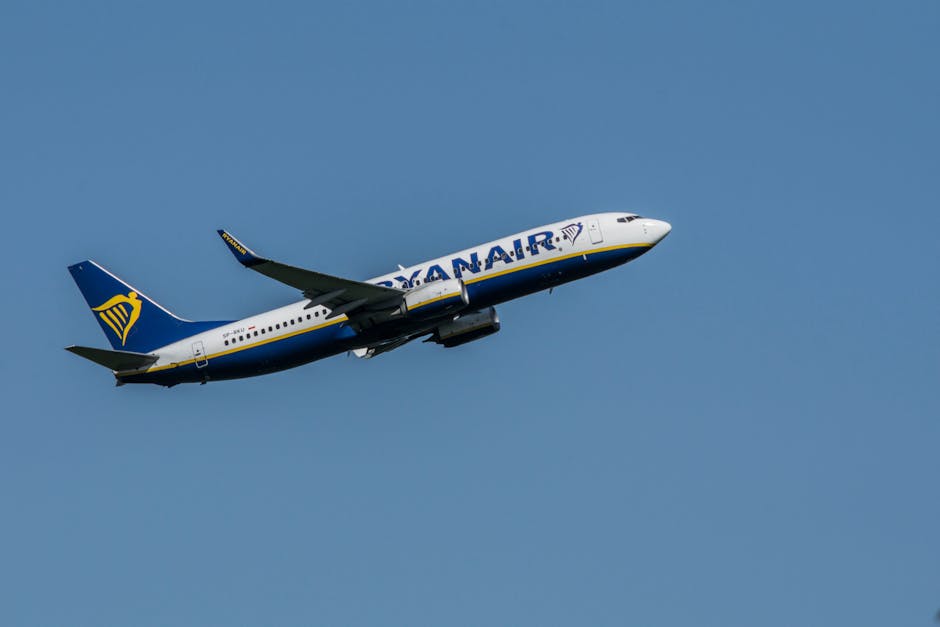 Ryanair Boeing 737 aircraft taking off in clear blue skies over Wrocław.