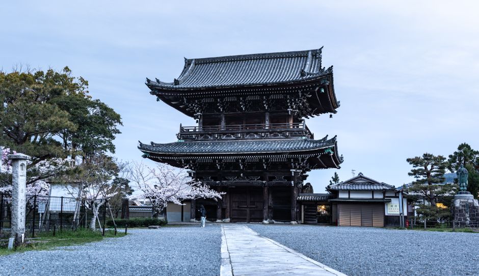 Stunning traditional Japanese pagoda surrounded by cherry blossoms in Kyoto, Japan, capturing spring's beauty.