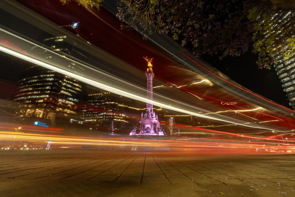 Long exposure photo of Angel de la Independencia in Mexico City with light trails at night.