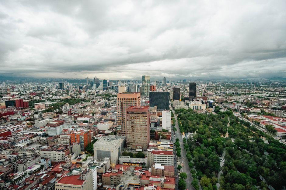 Discover the sprawling urban landscape of Mexico City under a dramatic cloudy sky.