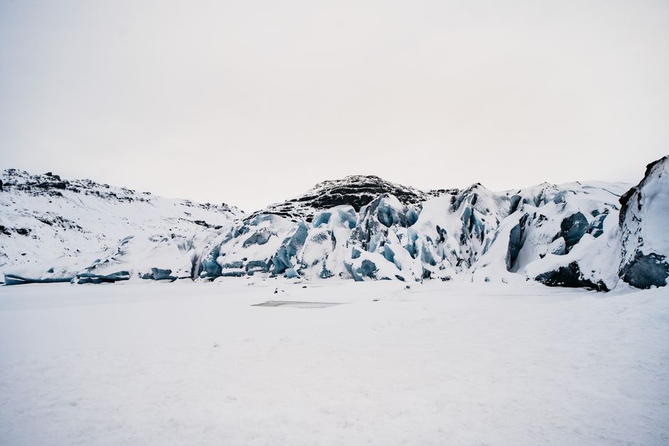 Stunning cold landscape showcasing snow-covered glacier and mountains in Iceland.