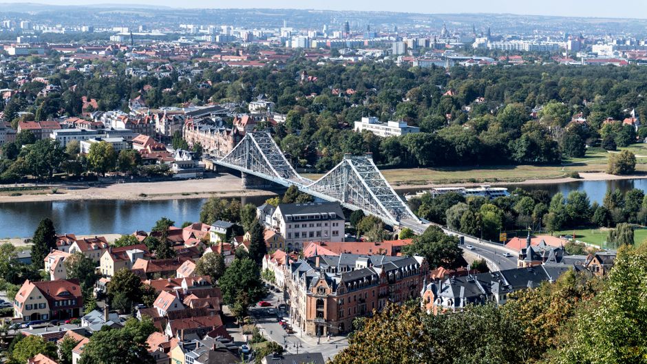 A stunning aerial shot of the Blue Wonder Bridge over the Elbe River in Dresden, Germany.