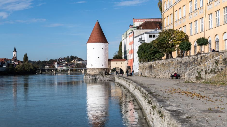Discover the charming riverside architecture of Passau, Germany, featuring iconic historic towers and scenic views.