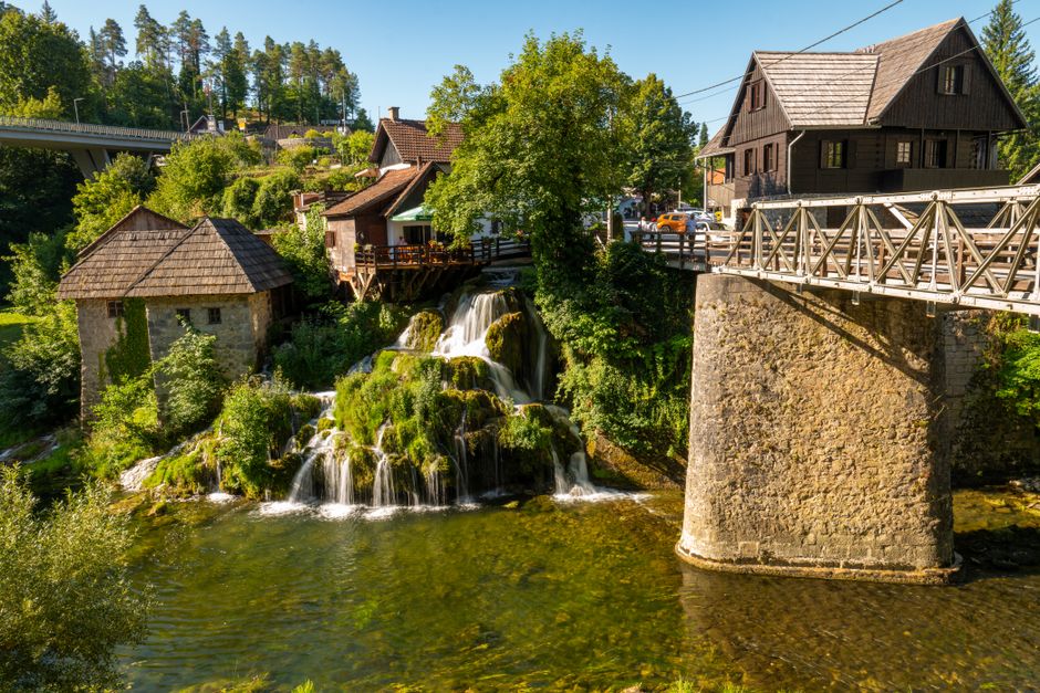 Idyllic view of a small waterfall and bridge in Slunj, Croatia.